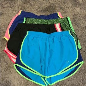 BUNDLE OF 4 woman’s size L Nike tempo shorts